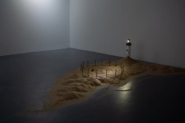 A small miniature of an island and lighthouse.