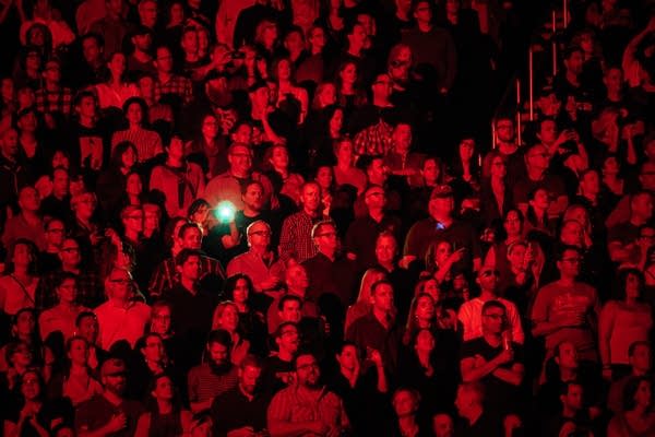 Music fans standing in a stadium