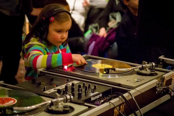 Avery Delaney of Minneapolis scratches records with DJ Freddy Fresh at Rock the Cradle, March 24, 2013.