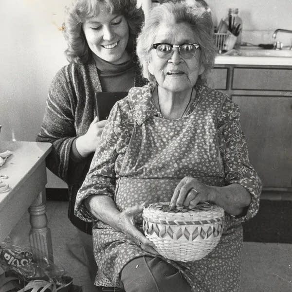 two women posing for photo in black and white