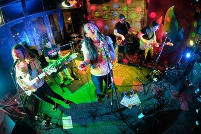 Six musicians performing onstage