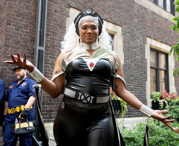 A woman dressed in cosplay poses as she gets her photo taken