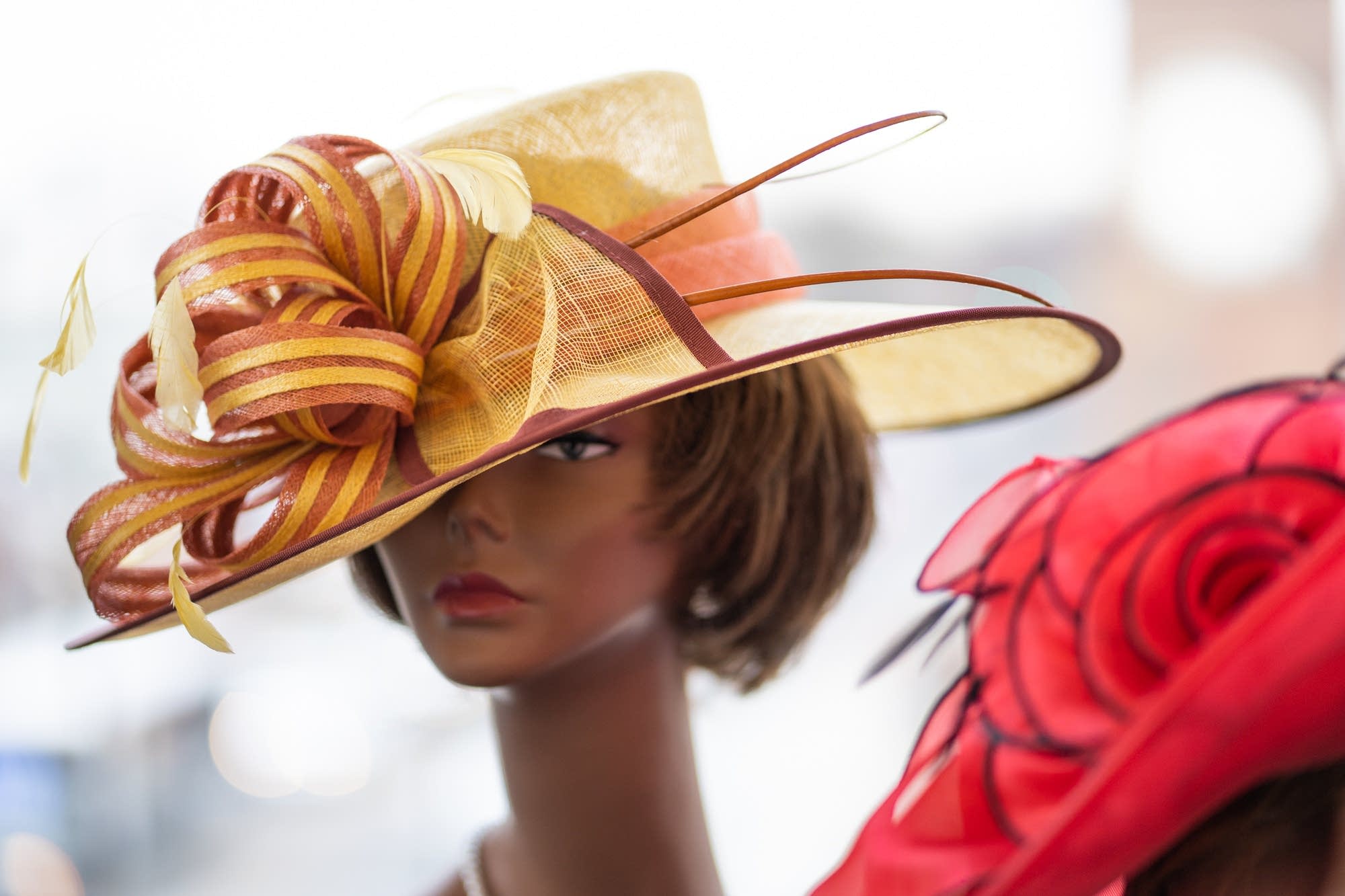 A church hat sits on a mannequin's head.