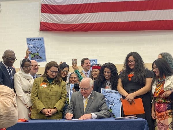 Gov. Tim Walz, prepares to sign a bill