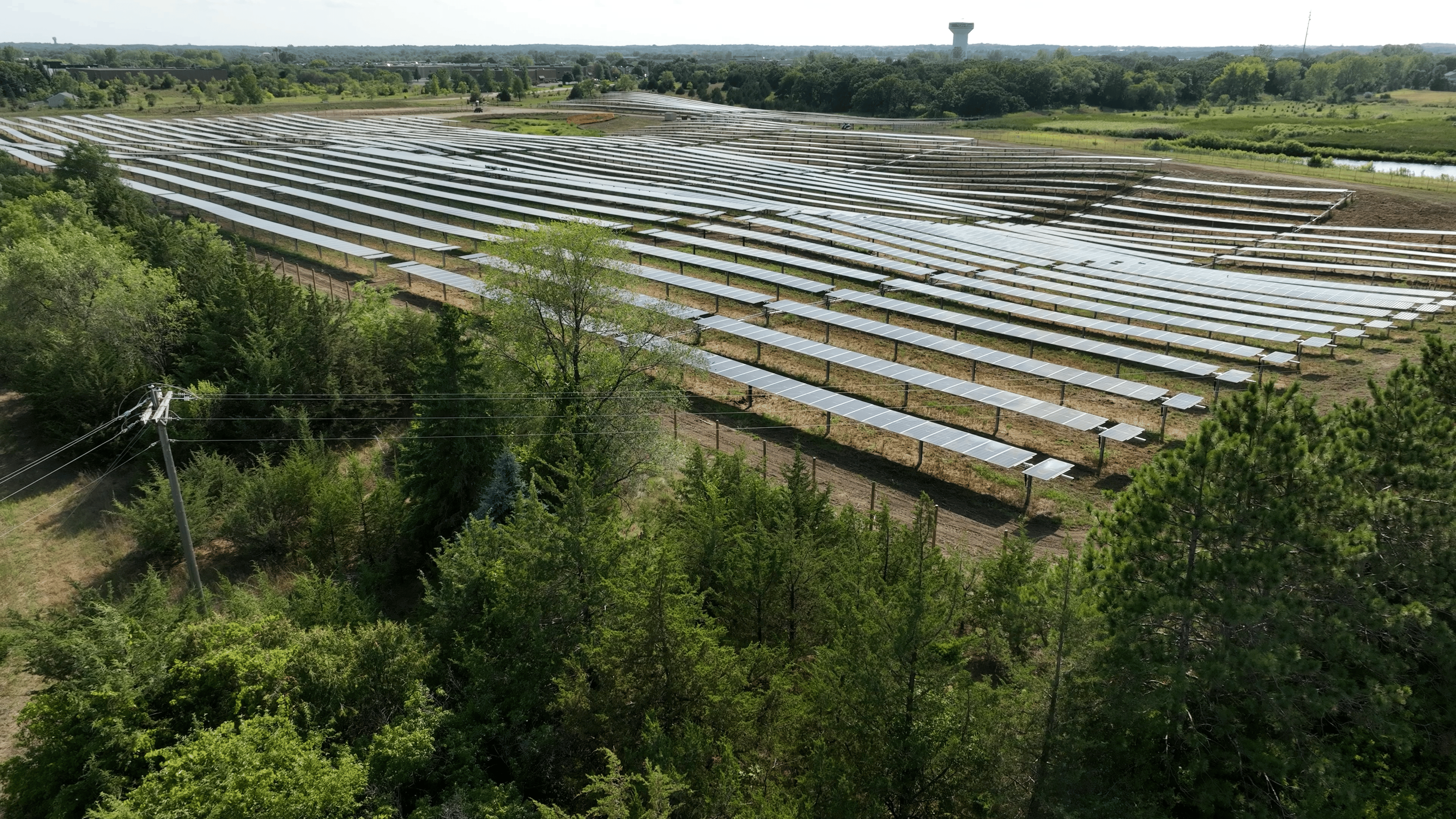 Wide shot of a solar panel array in a field.