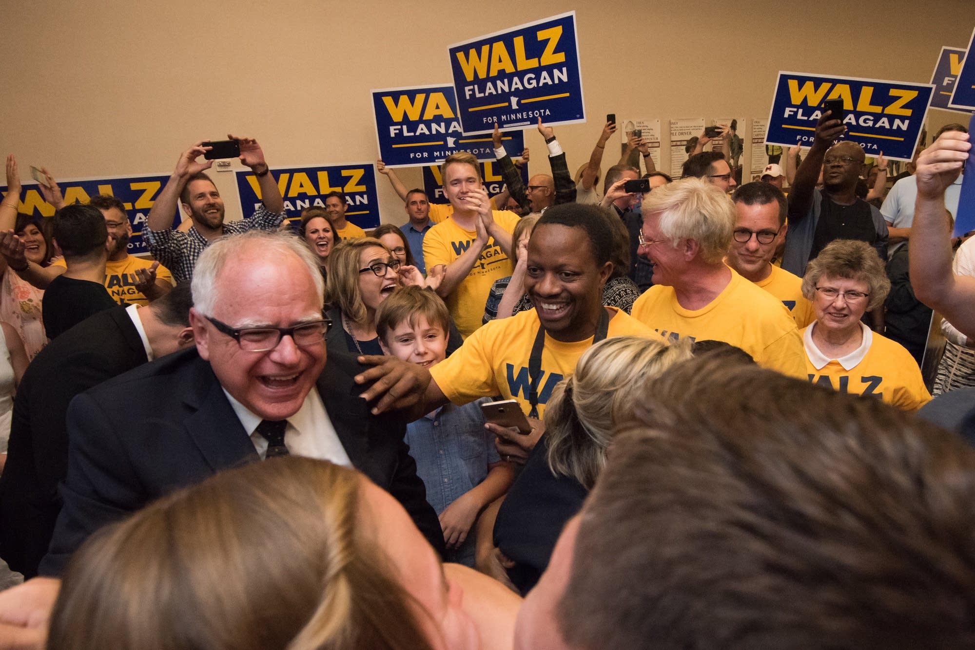 Walz greets supporters before a victory speech during a primary party.