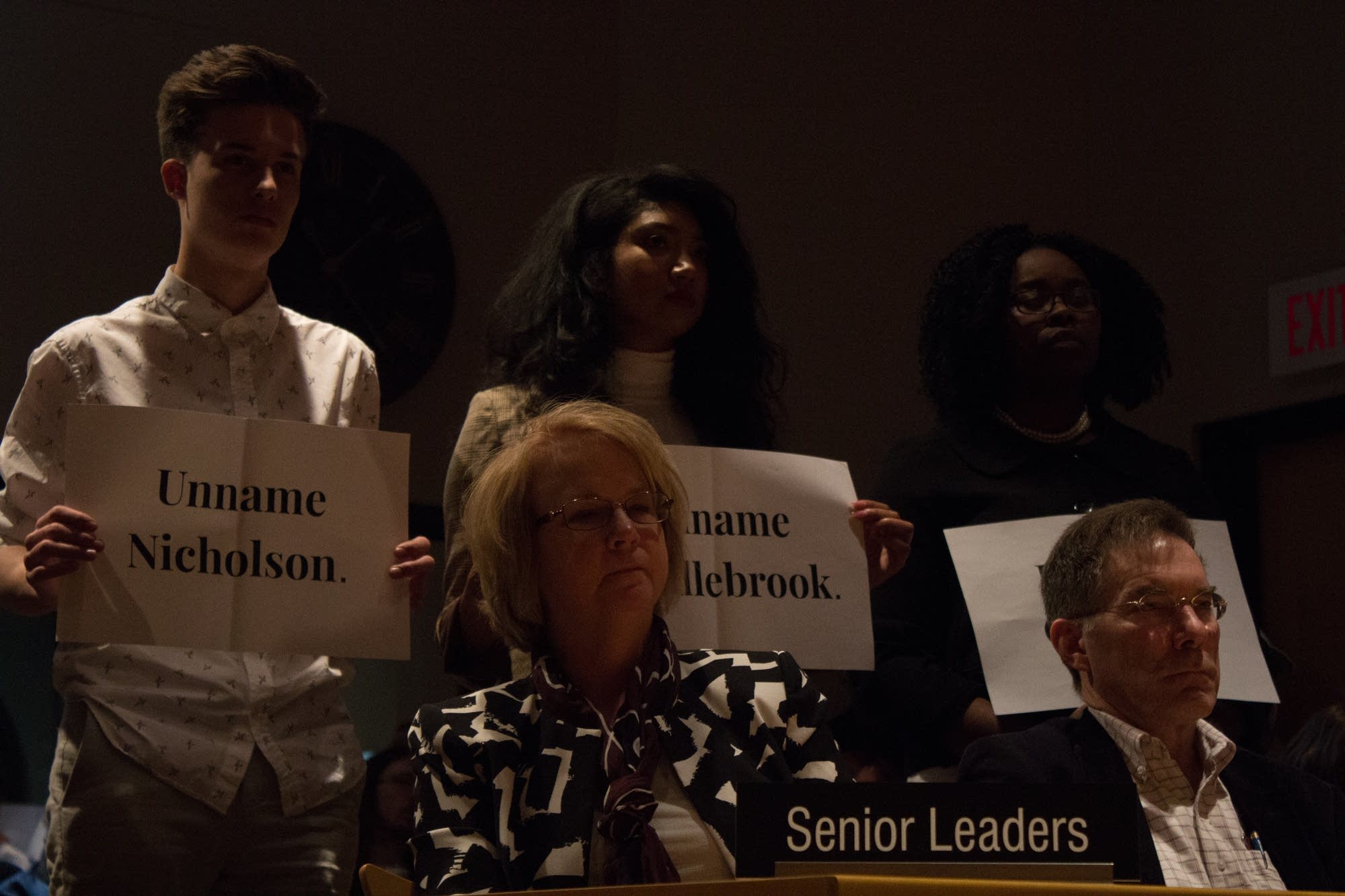 Students protest building names at a regents meeting