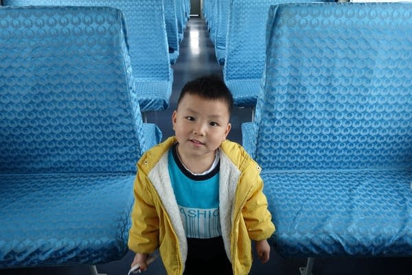 Chang Yuanhong's son has new clothes to wear, enough food to eat and running electricity at home - all things she didn't have growing up. (Charles Zhang/Marketplace)