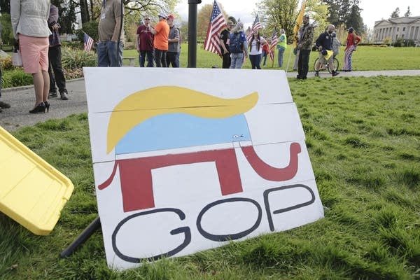 A Republican Party elephant logo is pictured with the hair of US President Donald Trump during a demonstration against Washington state's stay-home order at the state capitol in Olympia, Washington, on April 19, 2020. - Hundreds protested on April 18 in cities across America against coronavirus-related lockdowns -- with encouragement from President Donald Trump -- as resentment grows against the crippling economic cost of confinement. 