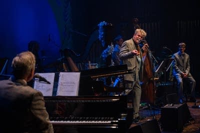 a band and performers on stage