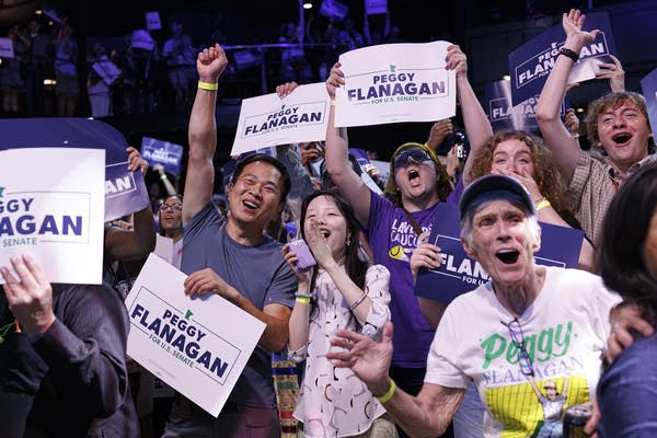 A crowd of supporters cheers for Peggy Flanagan.