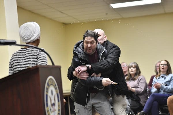 Man tackled after spraying Rep. Omar at town hall