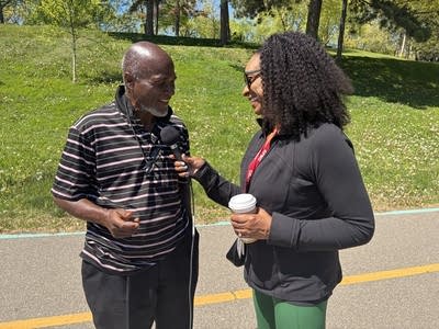 a man getting interviewed by a woman outside