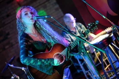 Two musicians performing onstage