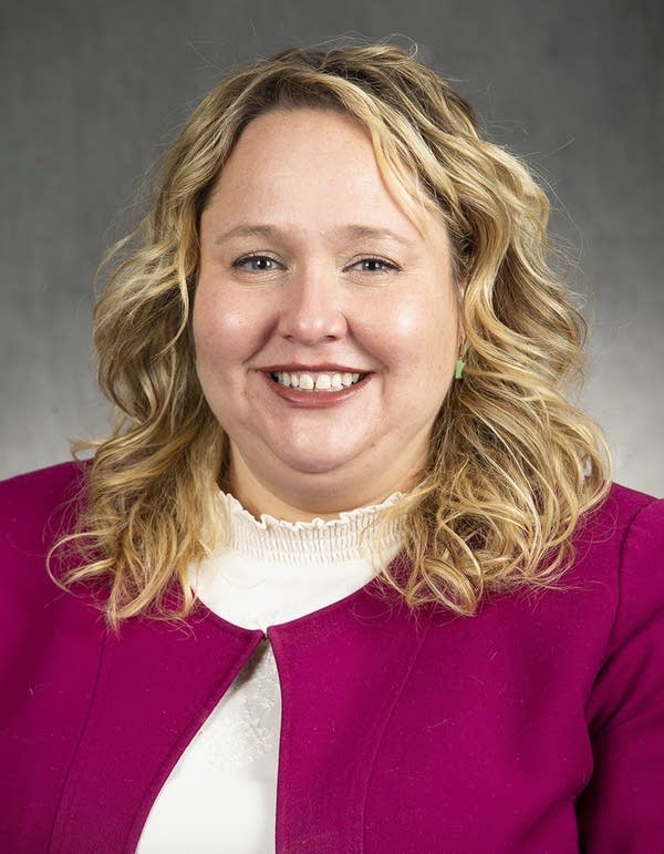 A portrait of a woman in a maroon jacket