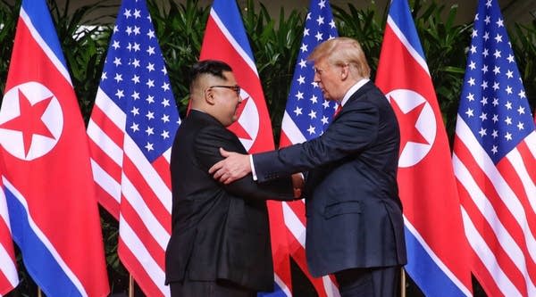 North Korean leader Kim Jong Un, left, shakes hands with U.S. President Donald Trump during their historic summit at the Capella Singapore hotel on Sentosa Island on Tuesday.