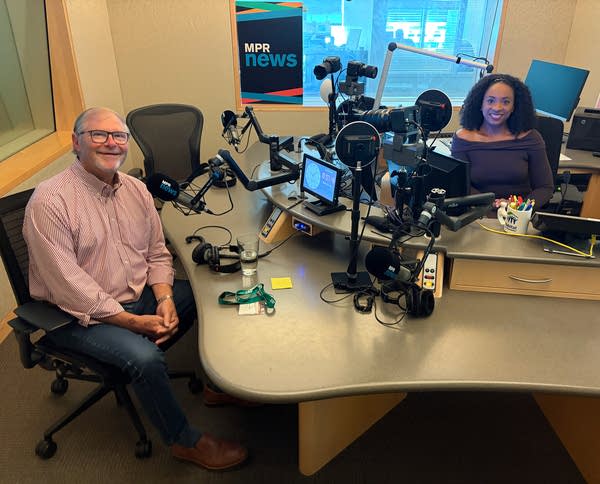man in radio studio with woman in host chair
