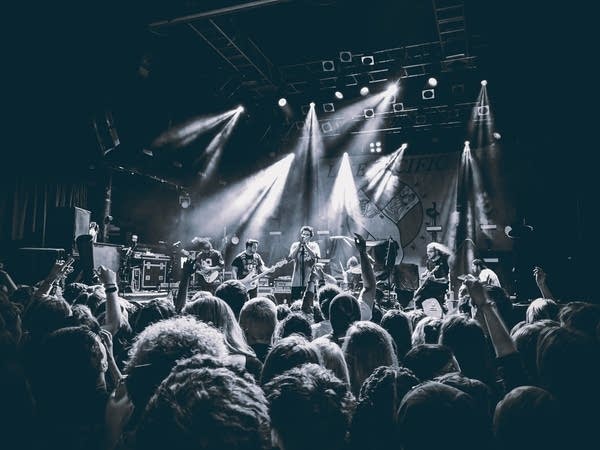 A band performing onstage in a music venue.