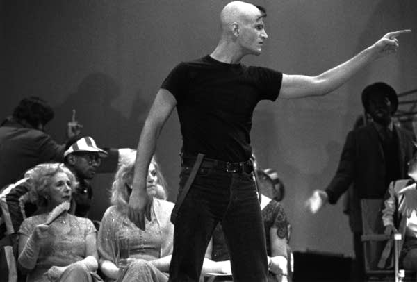 A black and white photo of a man pointing