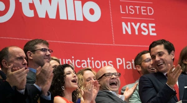 Twilio Inc. founder and CEO Jeff Lawson (C, in glasses) reacts after ringing the opening bell to celebrate Twilio's initial public offering at the New York Stock Exchange. 