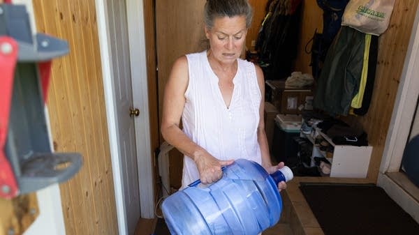 Lee Donahue lifts a 5-gallon bottle of drinking water