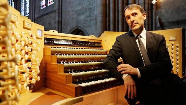 The French organist Olivier Latry sitting at an organ console. 