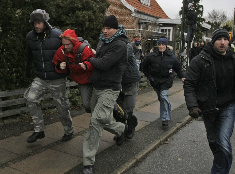Police officers arrest a protestor