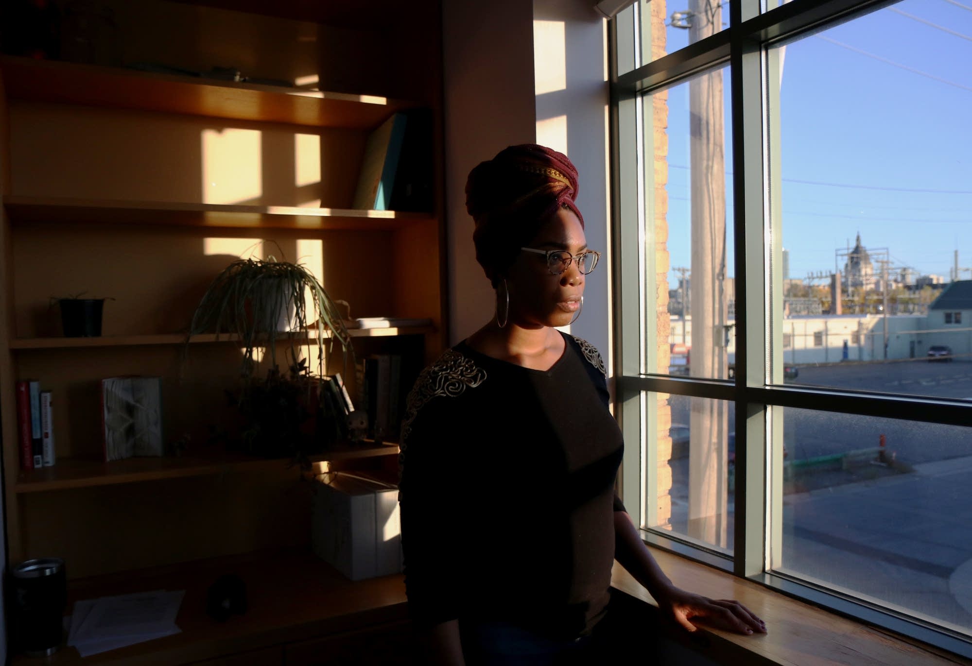 Me'Lea Connelly poses for a portrait in front of a window in her office