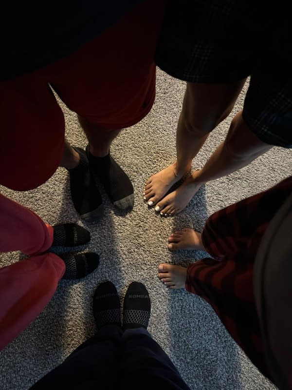 The feet of a family standing in a circle