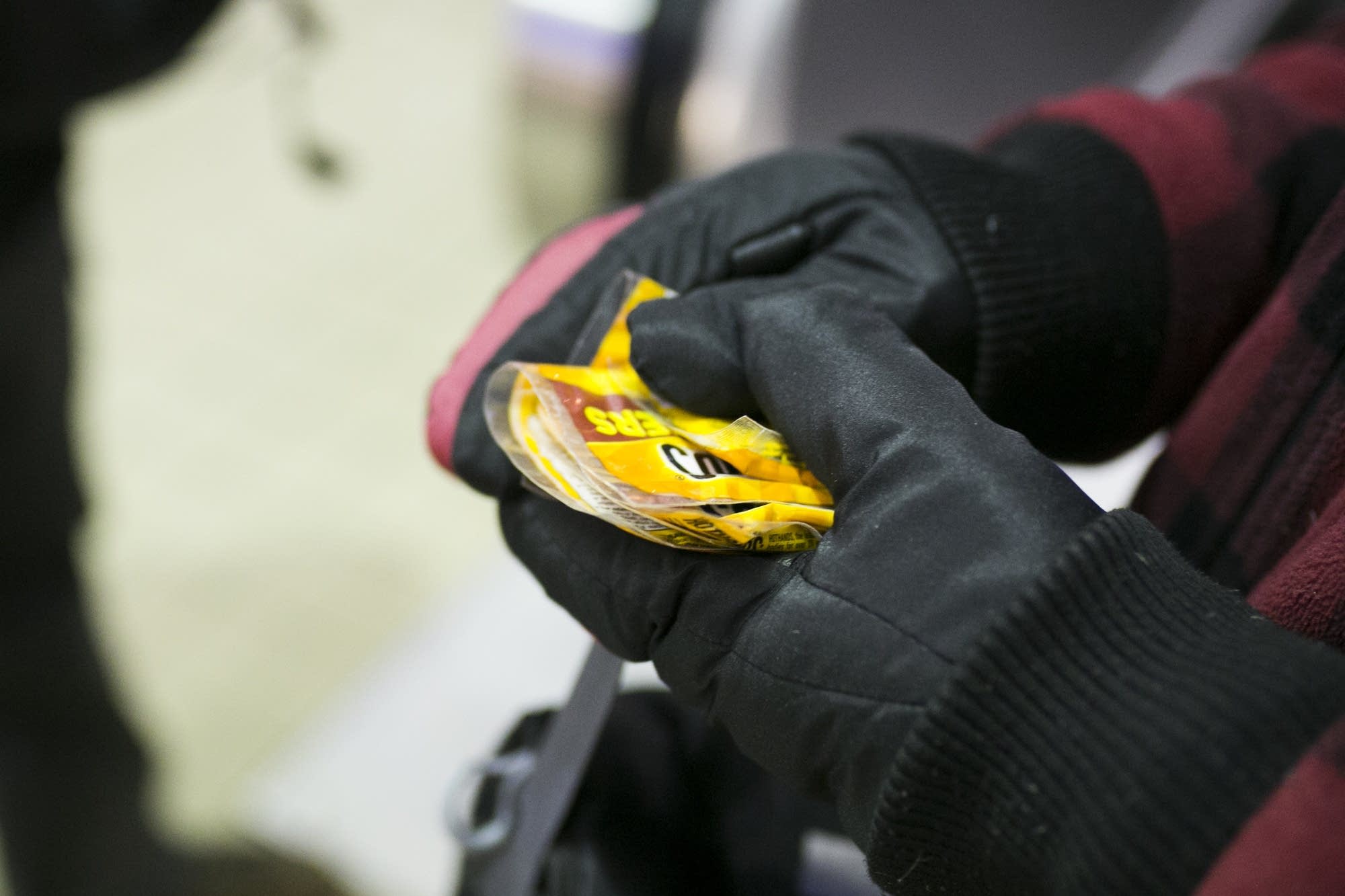 Gregory Graham holds packets of hand warmers