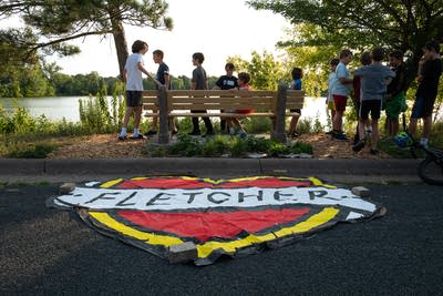 A sign saying Fletcher lays in front of a bench