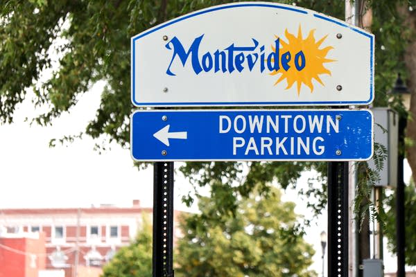 A white and blue road sign welcoming people to Montevideo, Minn.