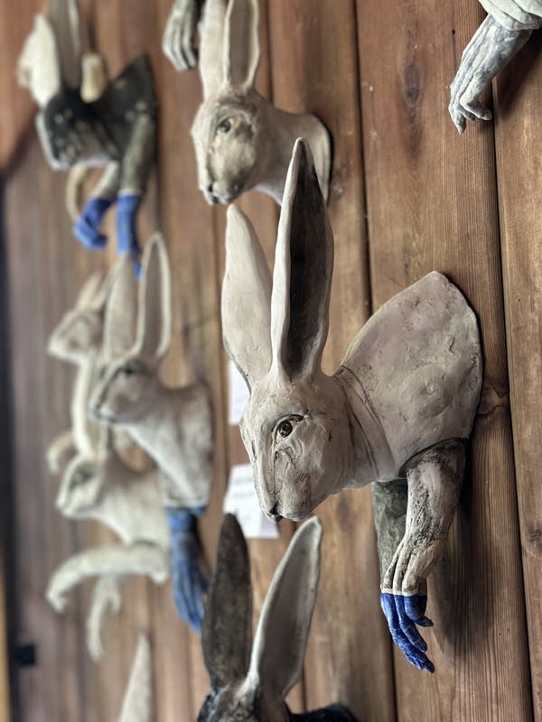 Ceramic rabbits hang from the wall.