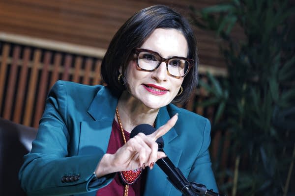 A woman speaks during a debate.