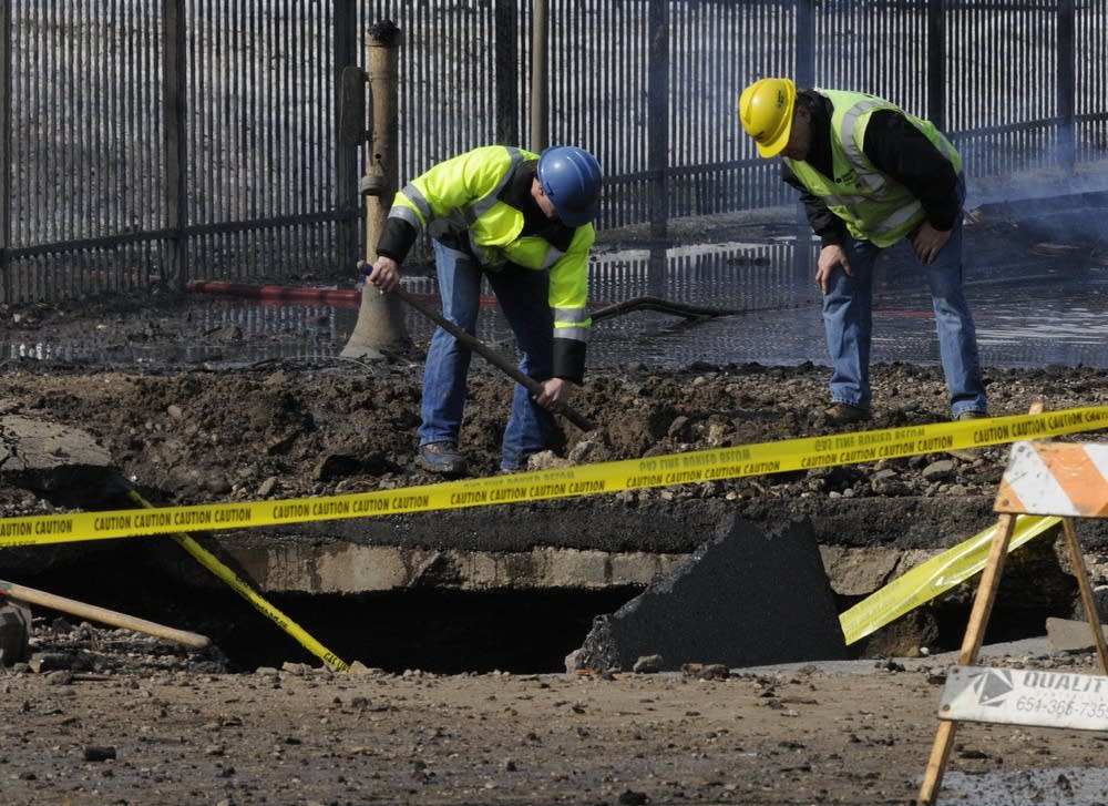 Workers inspect crater