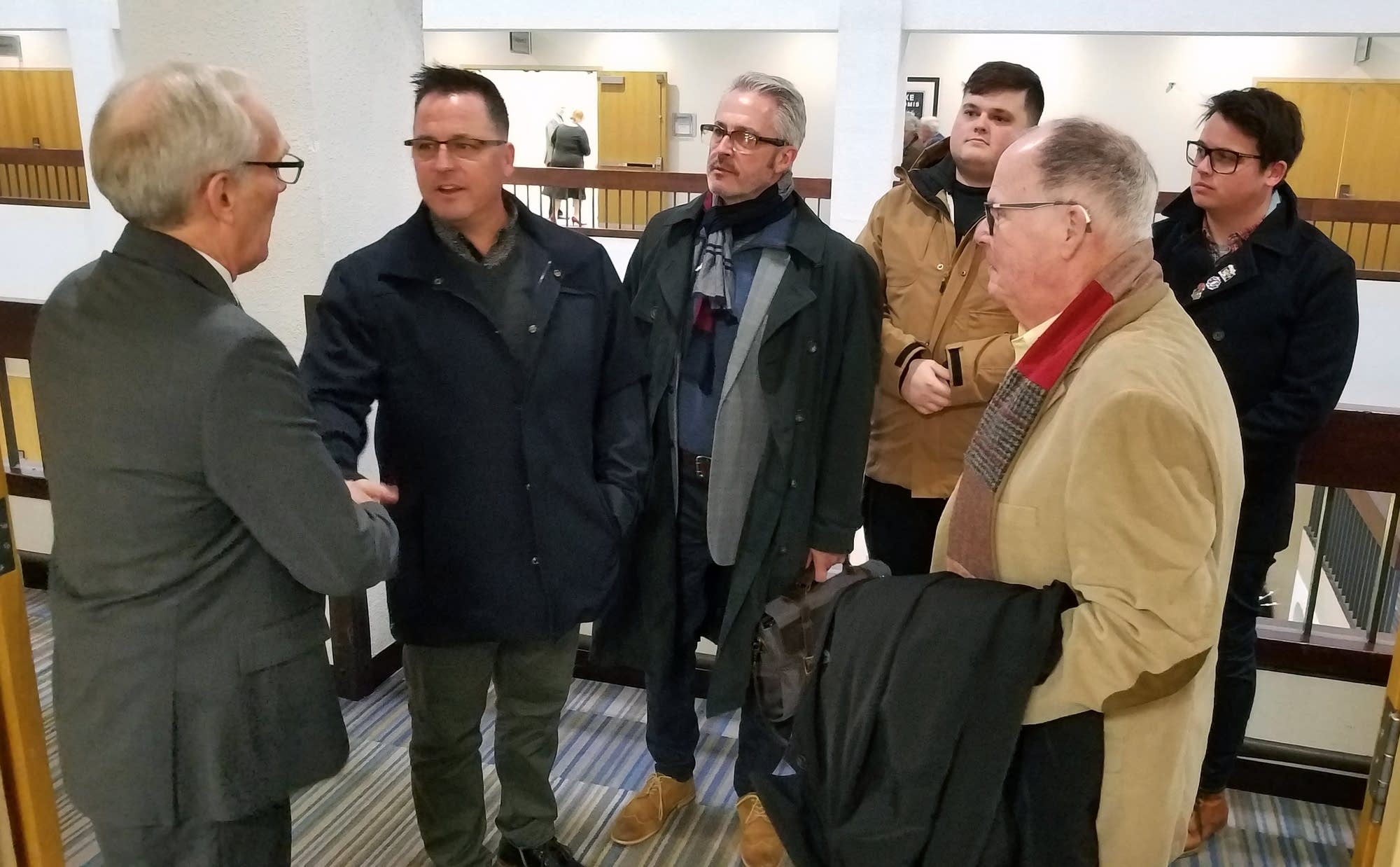 Jim Sinclair, left, shakes hands with Jim Keenan.