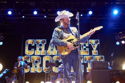 charley crockett performing on an outdoor stage at night