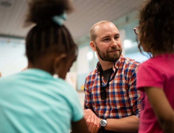 Kindergarten teacher Matt Proulx works with some of his students.