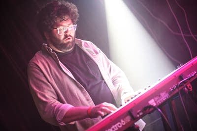 A musician plays keyboards onstage