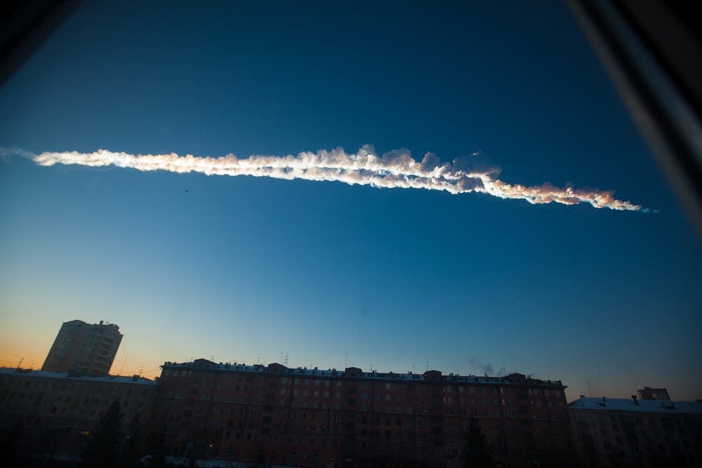 Contrail over buildings