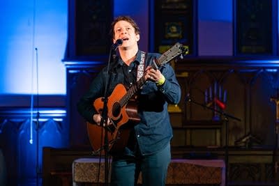 Man playing acoustic guitar and singing