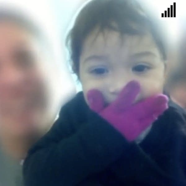 little girl with gloves blows kiss