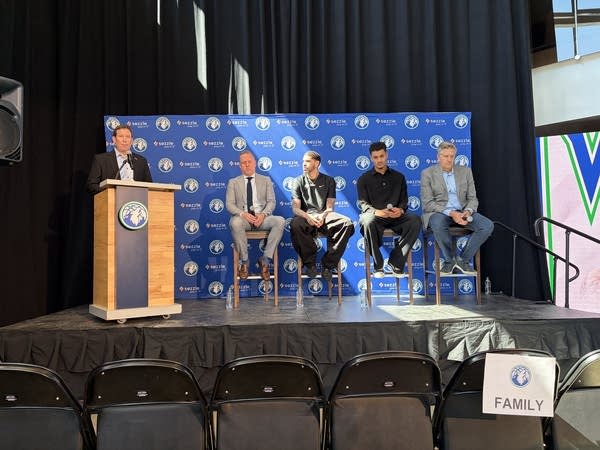LaMelo Ball and Josh Green sit side by side next to Tim Connelly and Chris Finch