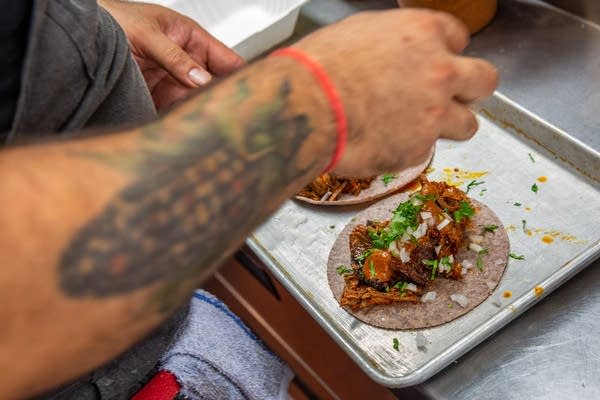 A man garnished a taco.