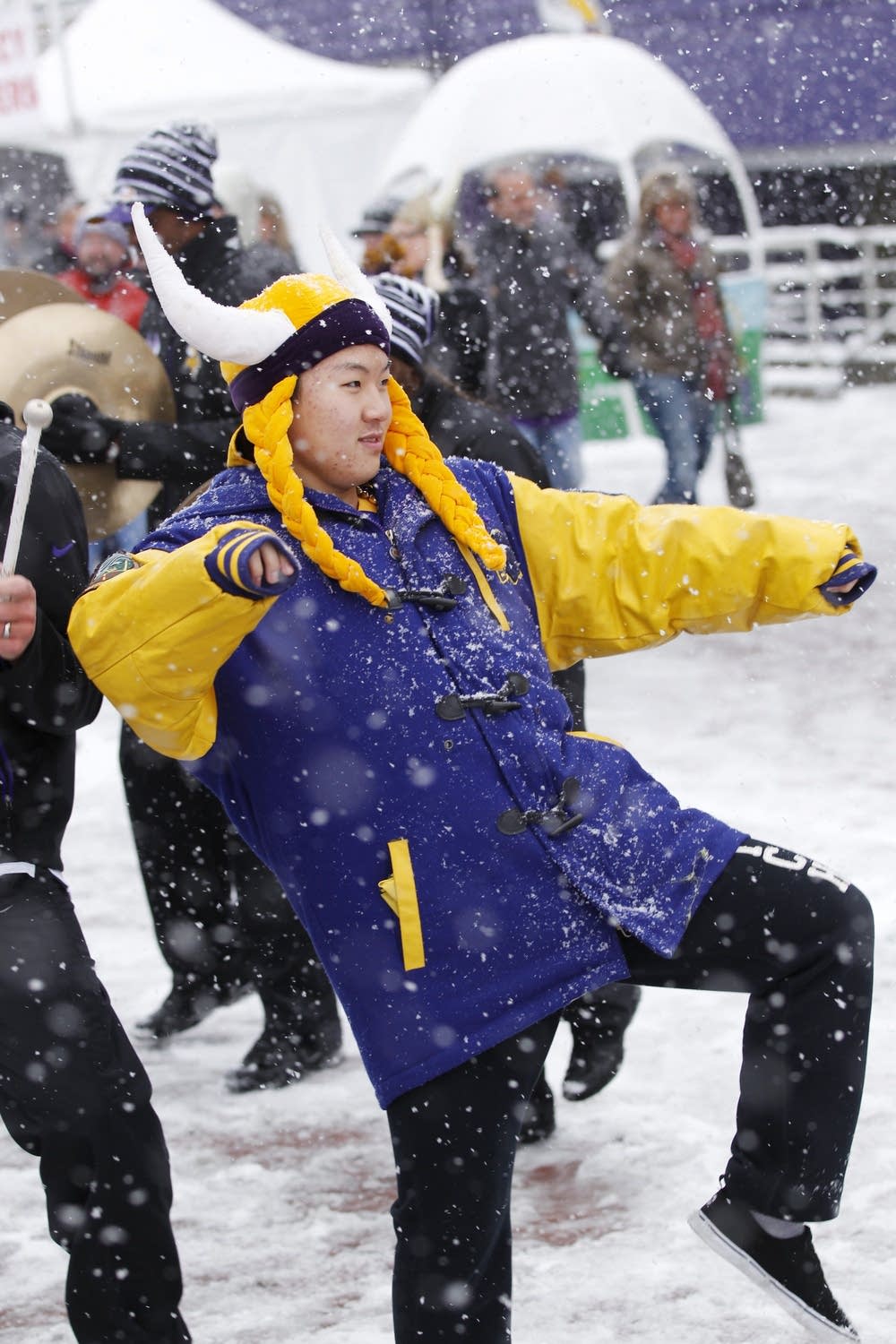 A Vikings fan dances in the snow