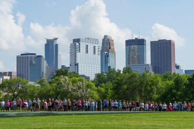 People stand by a mural in the park