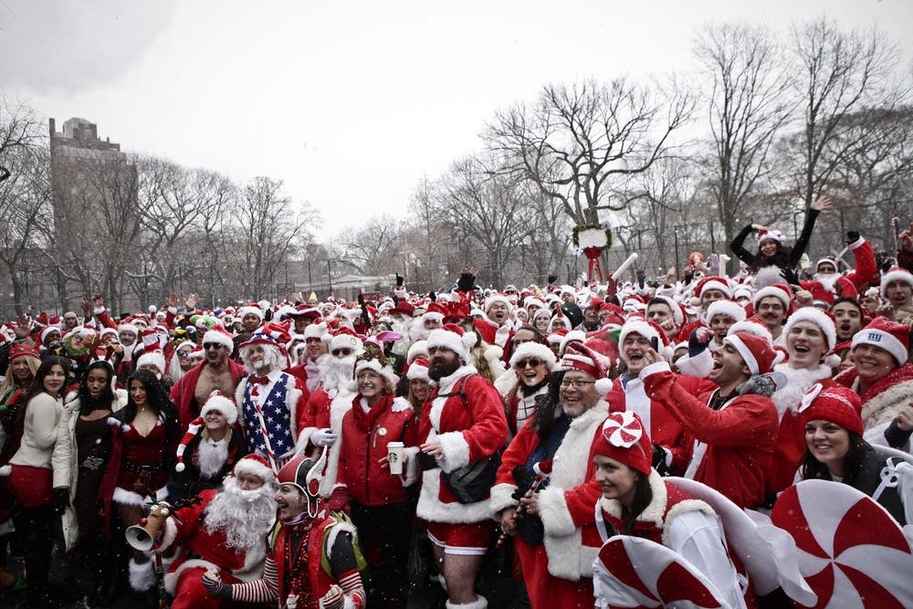 Revelers Dressed As Santa Take Part In Annual Bar