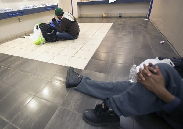 Homeless people of various ages and situations gather at the LRT.