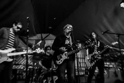 a rock band performing on an outdoor stage