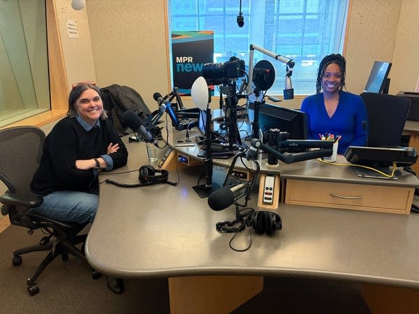 two women smiling in a broadcast studio